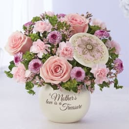 Pink roses and small purple flowers in a cream vase with a Mother's Day message