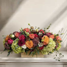 Mixed bouquet of roses and hydrangeas in a wooden box
