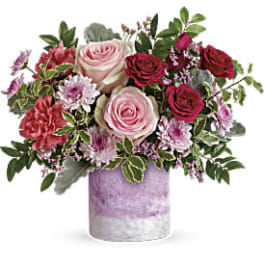 Pink and red roses in a lavender vase