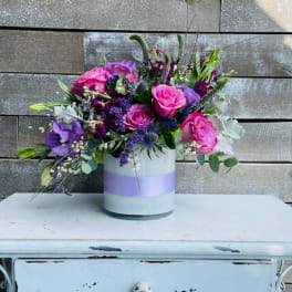 Bouquet of pink and purple flowers in a white vase