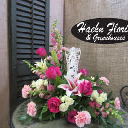 Pink and white floral arrangement with roses, lilies, and carnations