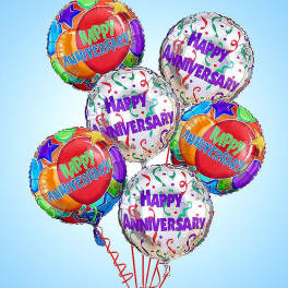 Cluster of colorful happy anniversary balloons on strings