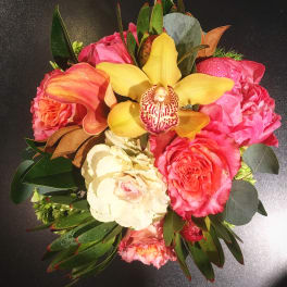 Bouquet of pink and cream roses with a yellow orchid