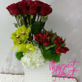 Bouquet of red roses, yellow orchids, and white hydrangea in a white wrap