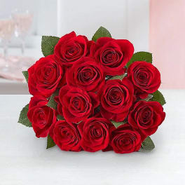 Bouquet of red roses with green leaves
