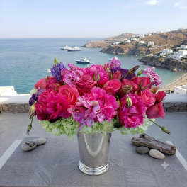 Pink and purple flower arrangement in a silver vase