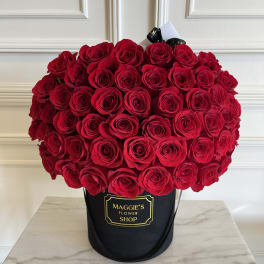Large bouquet of red roses in a black hatbox