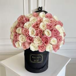 Bouquet of pink and white roses in a black hat box