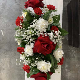 Red and white floral arrangement with roses, carnations, and baby's breath