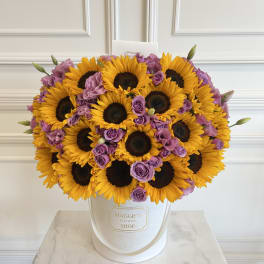 Sunflower and lavender rose bouquet in a white hat box
