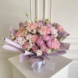 Pink bouquet with roses and carnations wrapped in lavender paper
