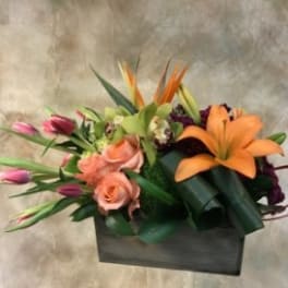Mixed bouquet with orange lilies, pink roses, and tulips in a black box