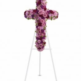 Purple and pink floral cross on a white easel