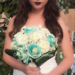 Bride holding a bouquet of white and turquoise roses