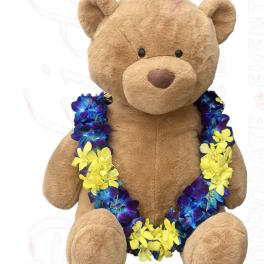 Plush teddy bear wearing a blue and yellow flower lei