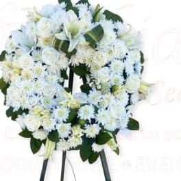 White floral wreath on a standing easel