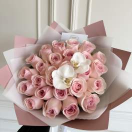 Bouquet of pink roses with two white orchids wrapped in pink paper