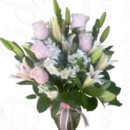 Bouquet of pink roses and white lilies in a glass vase