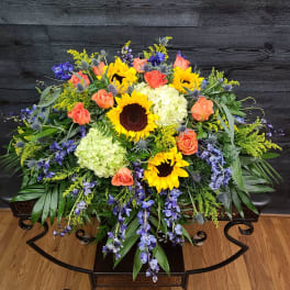 Large mixed bouquet with sunflowers, orange roses, and pale hydrangeas