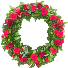 Heart-shaped floral wreath with pink and red flowers on a white background