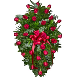 Heart-shaped rose wreath with a red ribbon bow