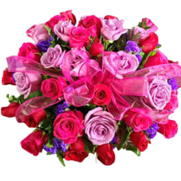 Bouquet of pink and red roses with a pink ribbon bow