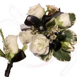 White rose boutonniere with black ribbon and variegated leaves
