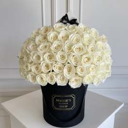 Large bouquet of white roses in a black hat box