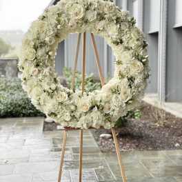 White floral wreath on a wooden easel