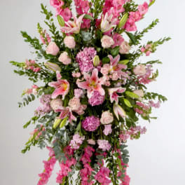 Tall pink floral standing spray with lilies, roses, and greenery