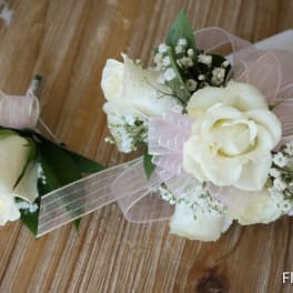 White rose boutonniere and corsage with pink ribbon and baby's breath