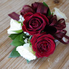 Small bouquet of red and white roses with burgundy ribbon