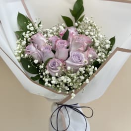 Lavender roses with baby's breath in white wrapping