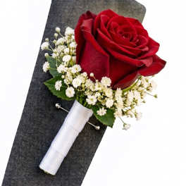 Red rose boutonniere with white baby's breath and a white ribbon wrap