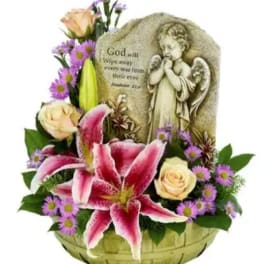 Basket arrangement with pink lilies, roses, and a memorial angel plaque