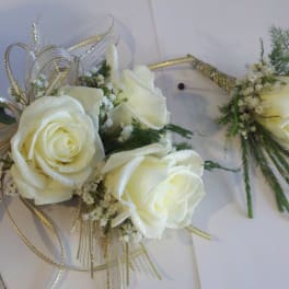 White rose corsage and boutonniere with gold ribbon accents