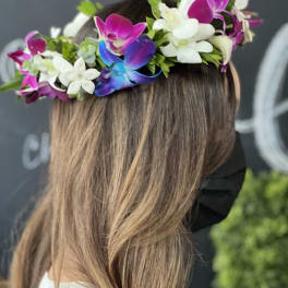 Flower crown with white and magenta orchids on a woman's head