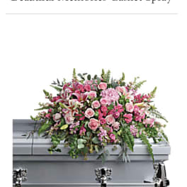 Pink casket spray with roses and lilies