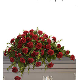 Red casket spray with carnations and greenery