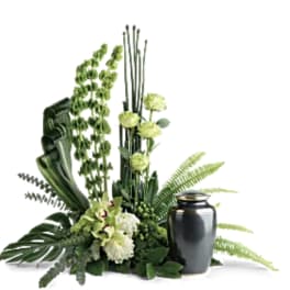 Green floral arrangement with a black urn