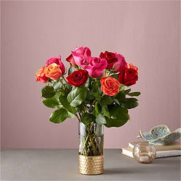 Bouquet of pink and red roses in a clear glass vase