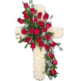 Cross-shaped floral arrangement with red roses and white flowers