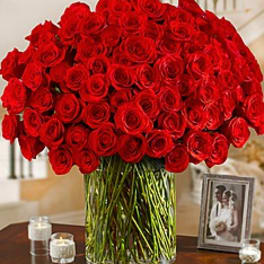 Large bouquet of red roses in a clear glass vase