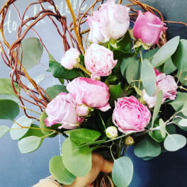 Pink roses with eucalyptus in a twig heart wreath