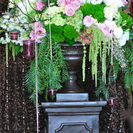 Large floral arrangement with pink and white blooms on a pedestal