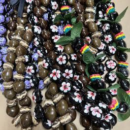 Assorted decorated chocolate candies with ribbon and leaf accents
