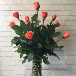 Coral rose bouquet in a clear glass vase