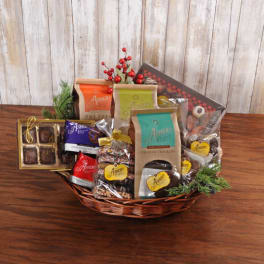 Gift basket filled with assorted packaged chocolates and snacks on a wooden table