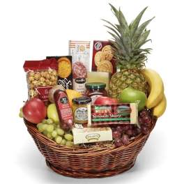 Fruit and snack gift basket with pineapple, bananas, grapes, and packaged cheeses and crackers