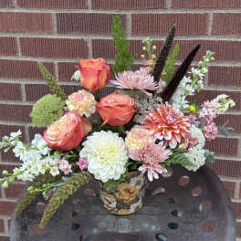 Mixed bouquet in a floral tin container with roses, dahlias, and chrysanthemums